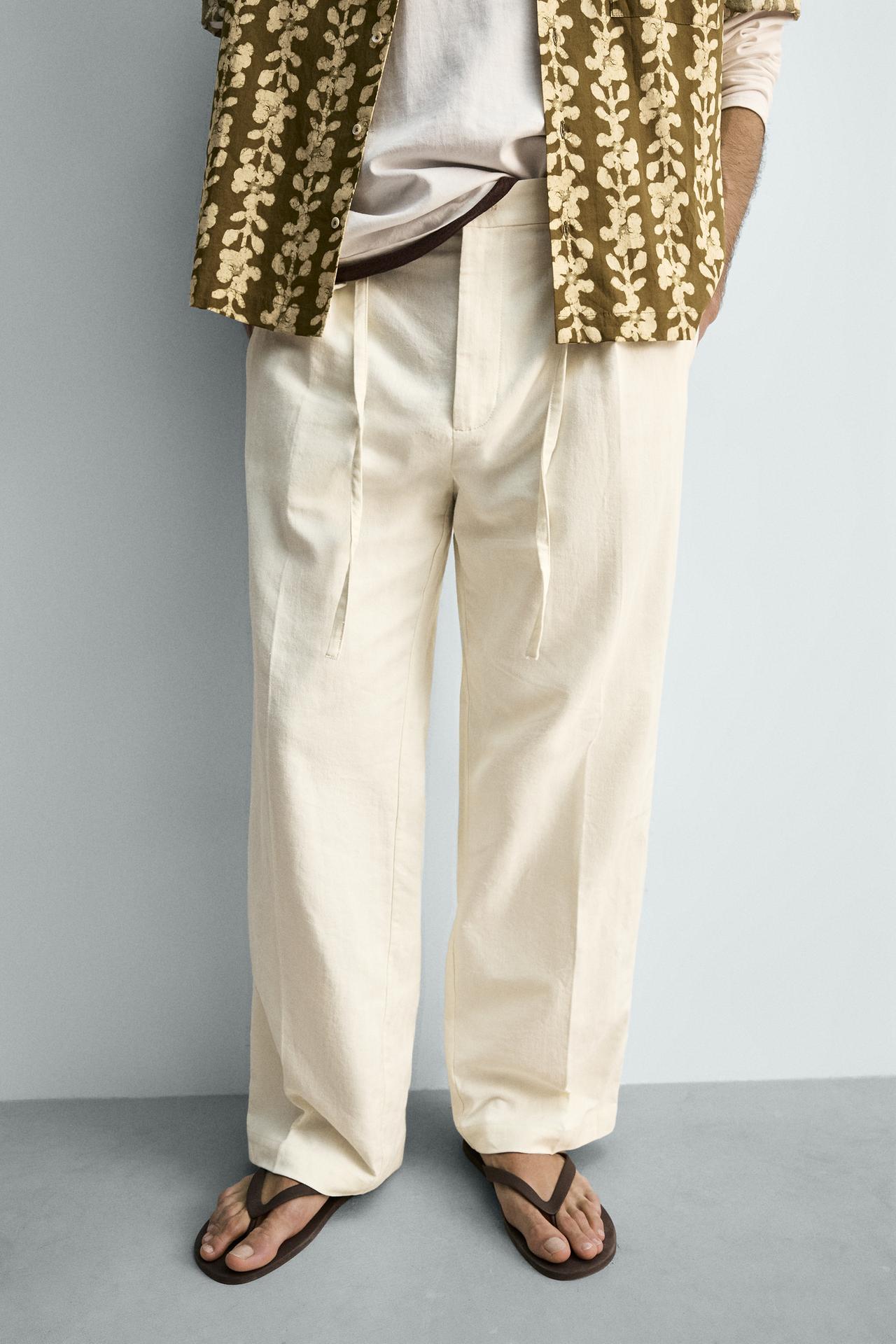 CALÇAS FLUIDAS COM PREGAS E CINTURA