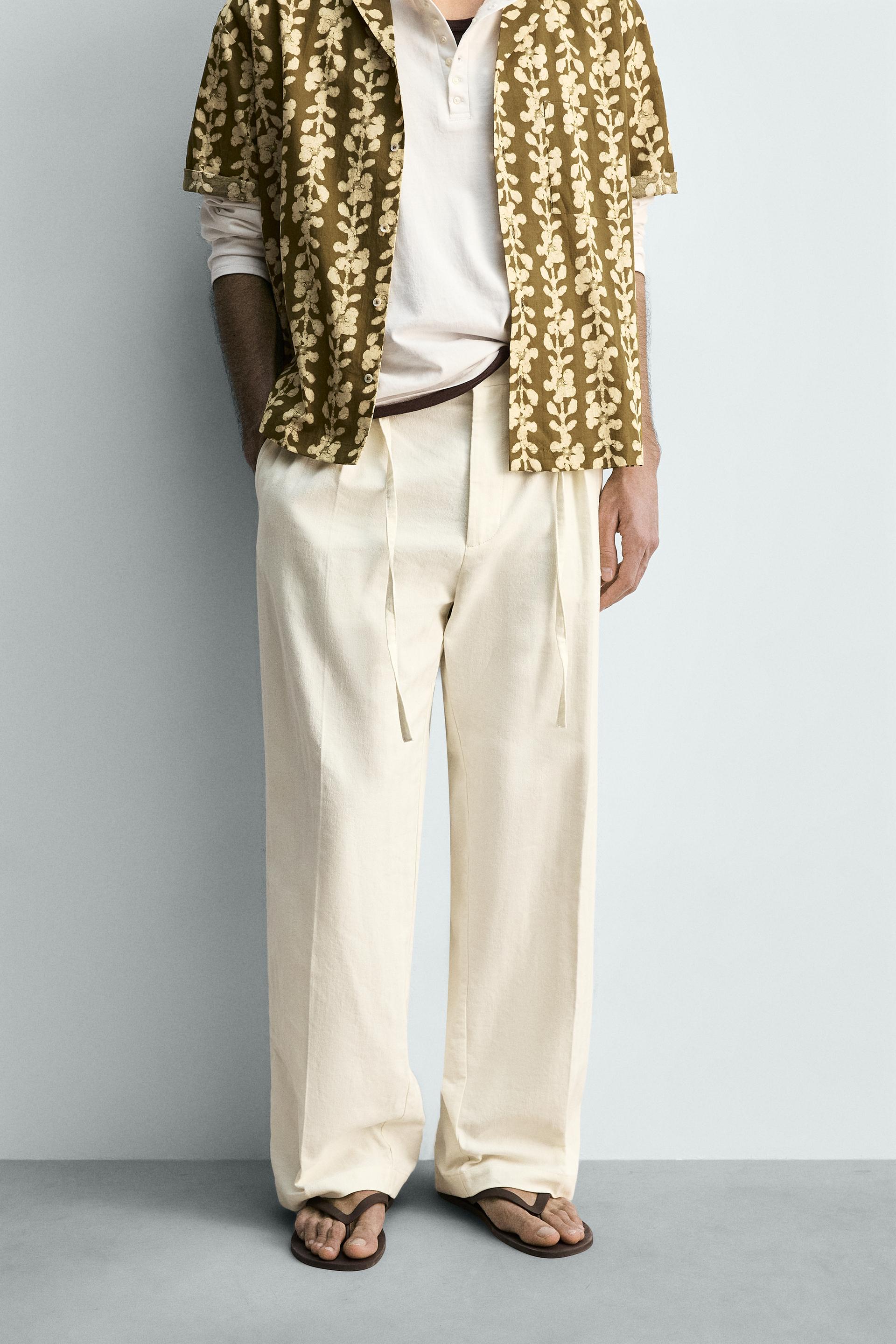 CALÇAS FLUIDAS COM PREGAS E CINTURA